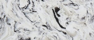 an Alaska Black quartz countertop surface that features colors of black, gray, and white blended in a swirling pattern