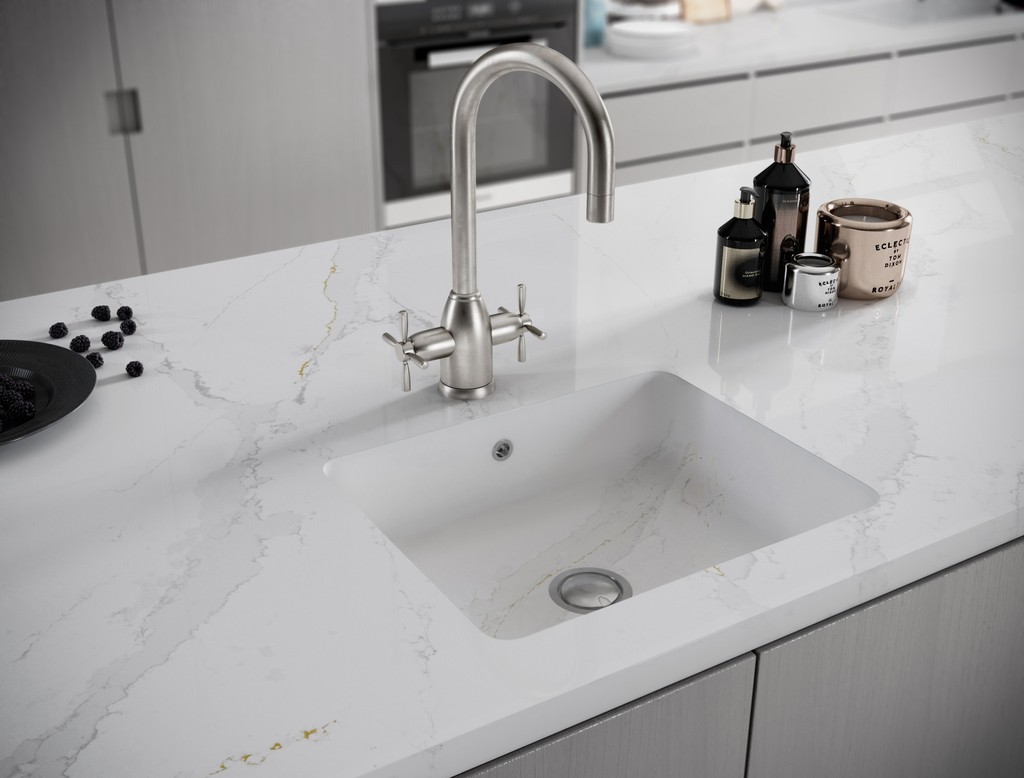 a wash area with a sink over the Et Calcatta Gold countertop surface