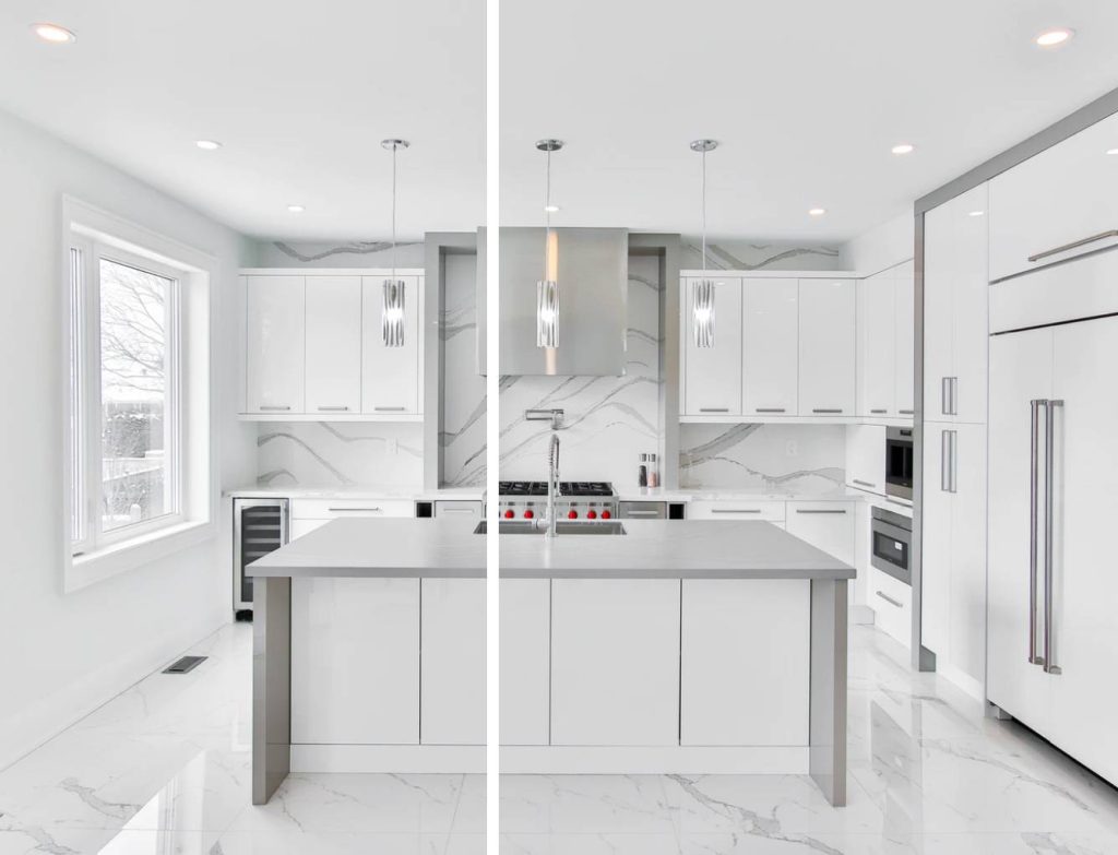a white kitchen with white marble floors, white cabinetry, gray waterfall kitchen island, and gray framing and silver details