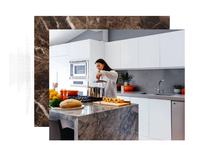 a woman cooking on a gray marble countertop inside a kitchen with white handleless cabinets and gray walls