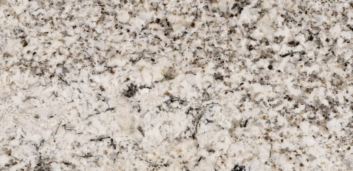 a stone that has black and brown specks over the creamy beige background