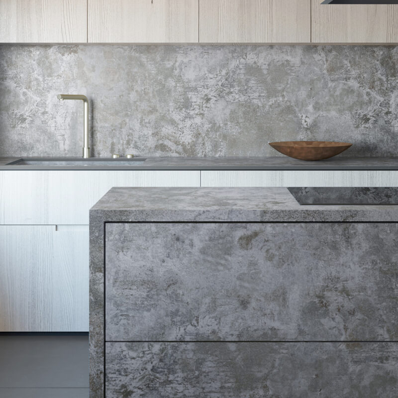 a concrete-finished industrial-style kitchen with an island and countertop with gray concrete surfaces.