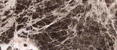 a New Emperador Dark marble countertop surface that features a range of dark, grays, and rich browns in a veining pattern over the dark background