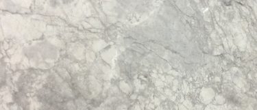 a super white marble countertop surface that has a dramatic white and gray veining pattern